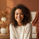 A young woman with a genuine smile on her face, looking directly at the viewer, conveying trust and satisfaction.